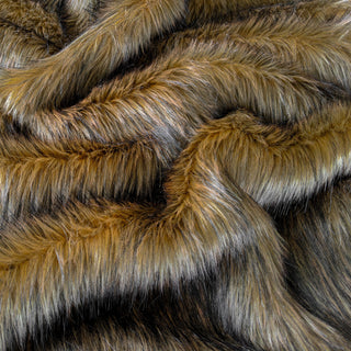 Brown faux fur fabric with folds.  A natural brown long pile fake fur fabric.