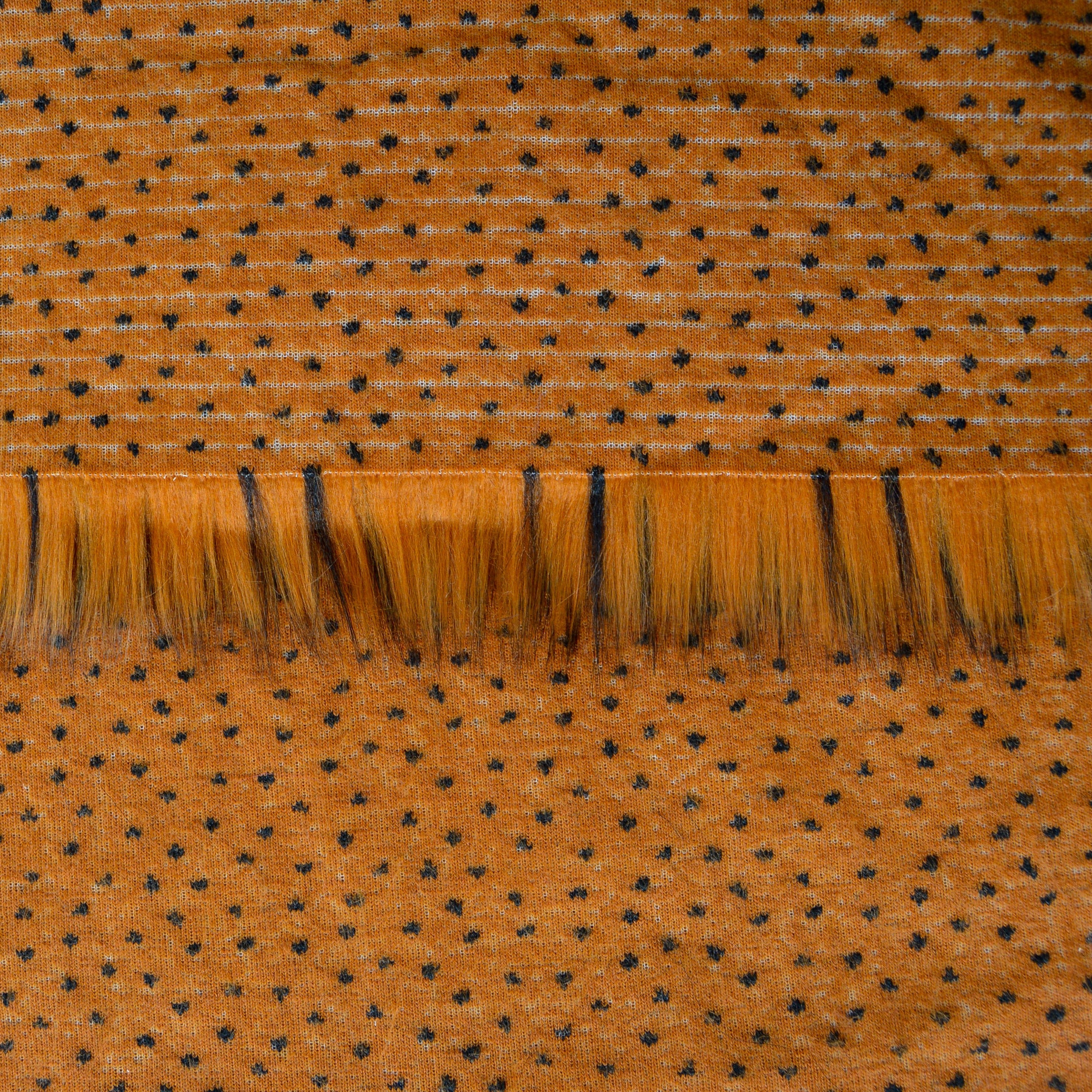 Backing of toffee brown faux fur fabric showing the long pile length of the fake fur.