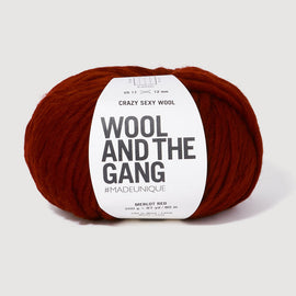 Red skein of yarn with 'Wool and the Gang' label on a white background