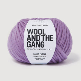 Purple yarn ball with 'Wool and the Gang' label on a light gray background