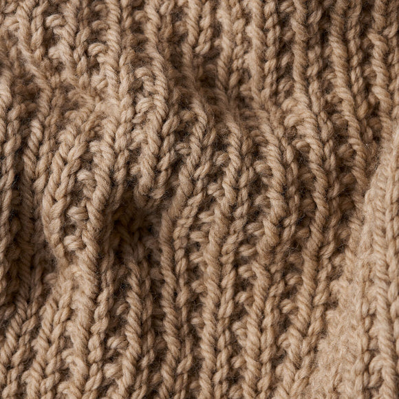 Close-up of beige knitted fabric texture