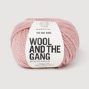 Ball of pink yarn with 'Wool and the Gang' label on a white background