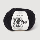Black yarn skein with 'Wool and the Gang' label on a light gray background