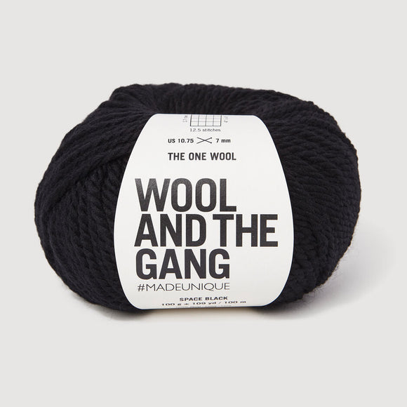 Black yarn skein with 'Wool and the Gang' label on a light gray background