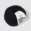 Black skein of yarn with 'Wool and the Gang' label on a light gray background