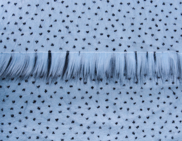 Blue Steel faux fur fabric.  It is icy light blue laid flat showing the long pile fake fur fabric length