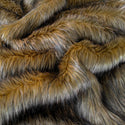 Brown faux fur fabric with folds.  A natural brown long pile fake fur fabric.