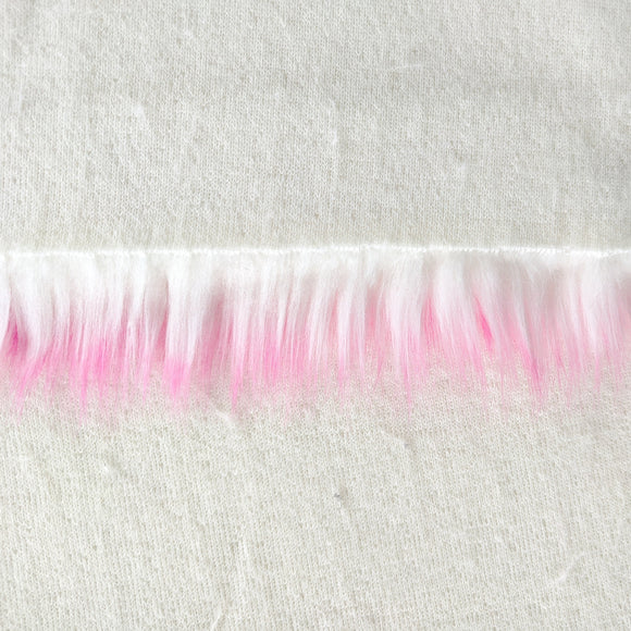 Backing of bubblegum faux fur fabric showing the long pile length of the fake fur.  The color bubblegum has a white base with pink tips.