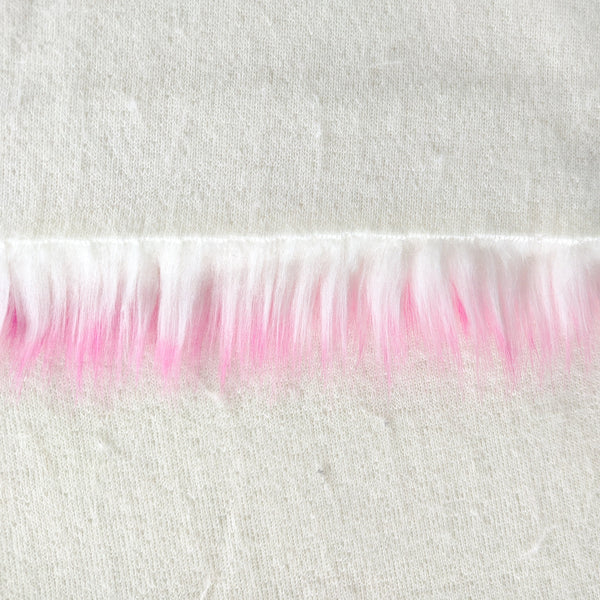 Backing of bubblegum faux fur fabric showing the long pile length of the fake fur.  The color bubblegum has a white base with pink tips.