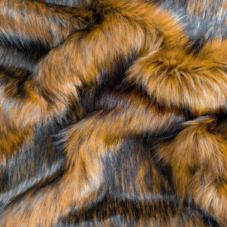 Chestnut faux fur fabric with folds.  A natural brown long pile fake fur fabric.