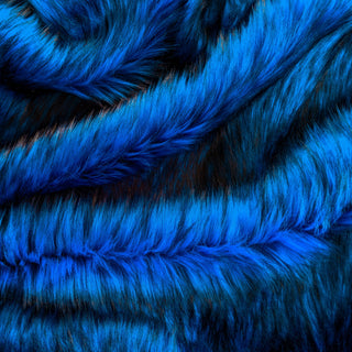Cobalt faux fur fabric with folds.  Cobalt is a medium-dark blue long pile fake fur fabric.