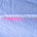 Backing of dreamsicle faux fur fabric showing the long pile length of the fake fur.  The dreamsicle color has a light blue backing.  It is a long pile faux fur fabric.