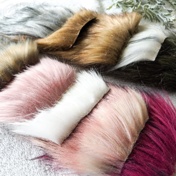 stack of pre-cut squares to make faux fur pom poms