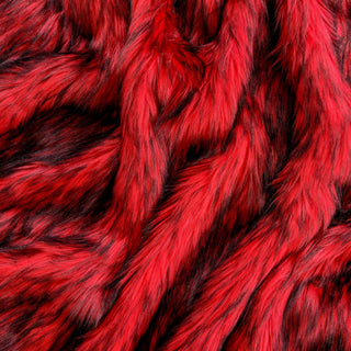 Fire red faux fur fabric with folds.  A red long pile fake fur fabric.