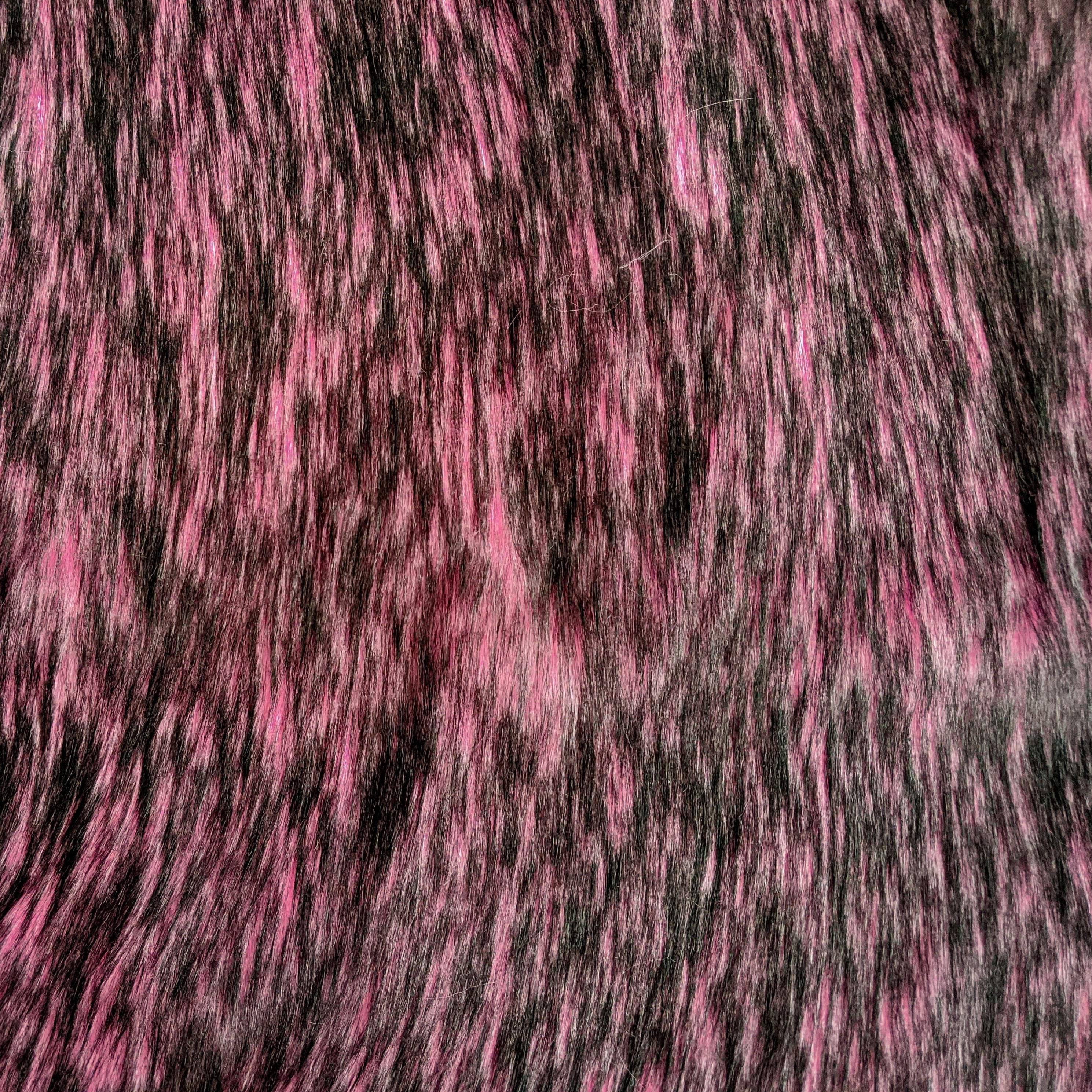 Long pile flamingo pink faux fur fabric laid flat.