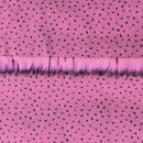 Backing of flamingo pink faux fur fabric showing the long pile length of the fake fur.