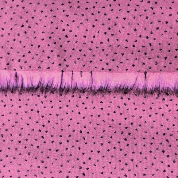 Backing of flamingo pink faux fur fabric showing the long pile length of the fake fur.