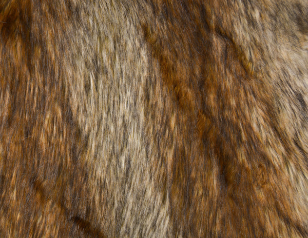 Long pile natural golden brown faux fur fabric laid flat.