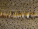 Backing of golden brown faux fur fabric showing the long pile length of the fake fur.