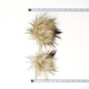 Latte faux fur pom poms with measuring tapes.