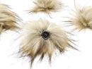 Latte faux fur pom pom with a metal snap.