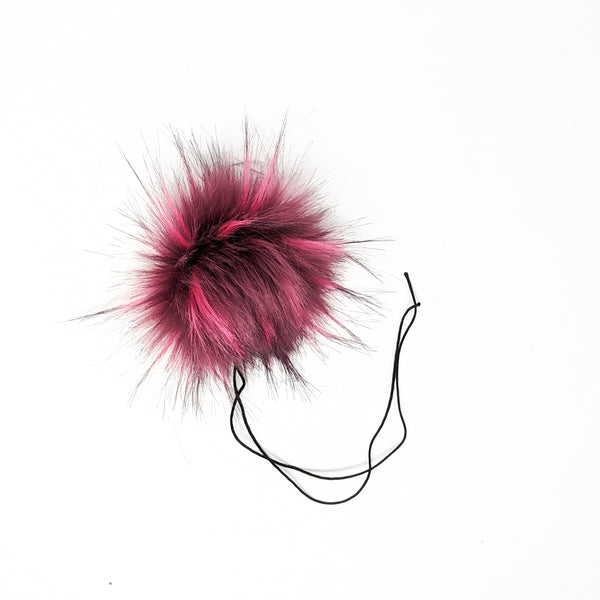Raspberry faux fur pom pom with a thick nylon string.