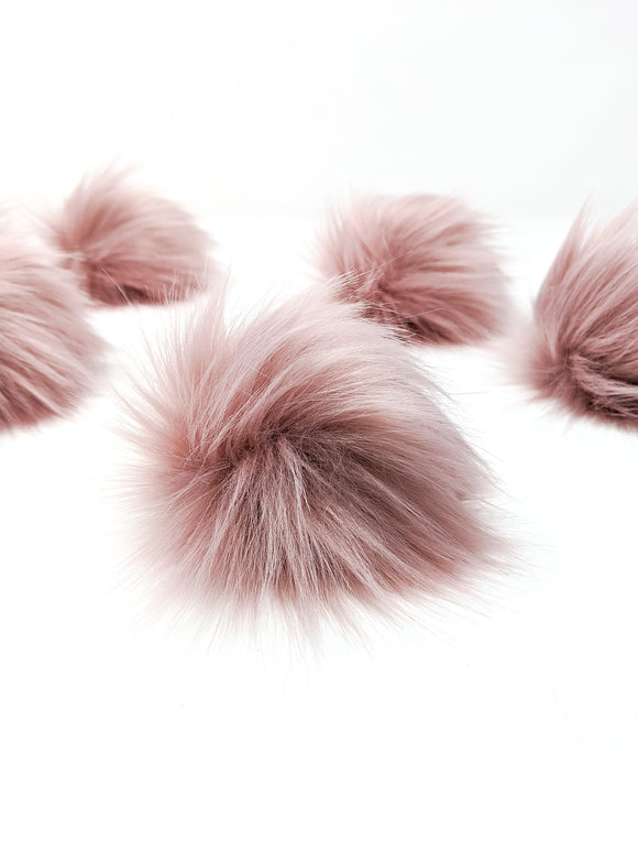 Rose blush faux fur pom poms.