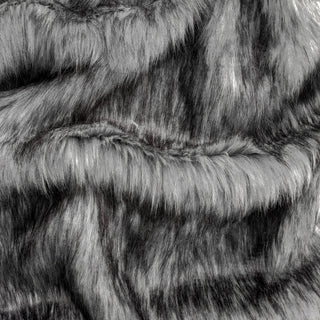 Slate grey faux fur fabric with folds.  A natural gray long pile fake fur fabric.
