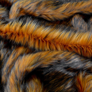 Toffee brown faux fur fabric with folds.  A brown long pile fake fur fabric.