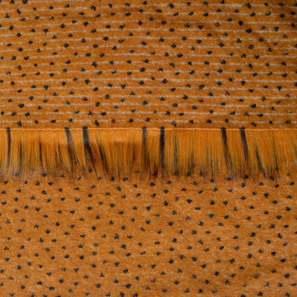 Backing of toffee brown faux fur fabric showing the long pile length of the fake fur.