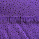 Backing of violet purple faux fur fabric showing the long pile length of the fake fur.