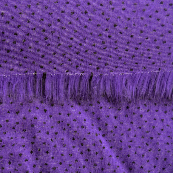 Backing of violet purple faux fur fabric showing the long pile length of the fake fur.