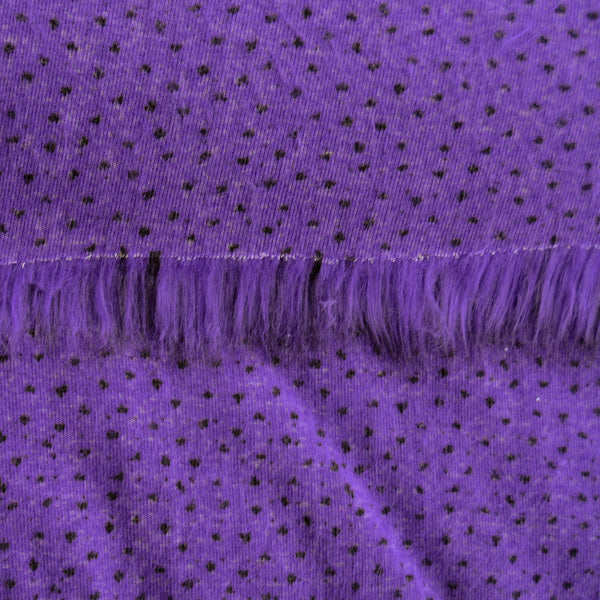 Backing of violet purple faux fur fabric showing the long pile length of the fake fur.